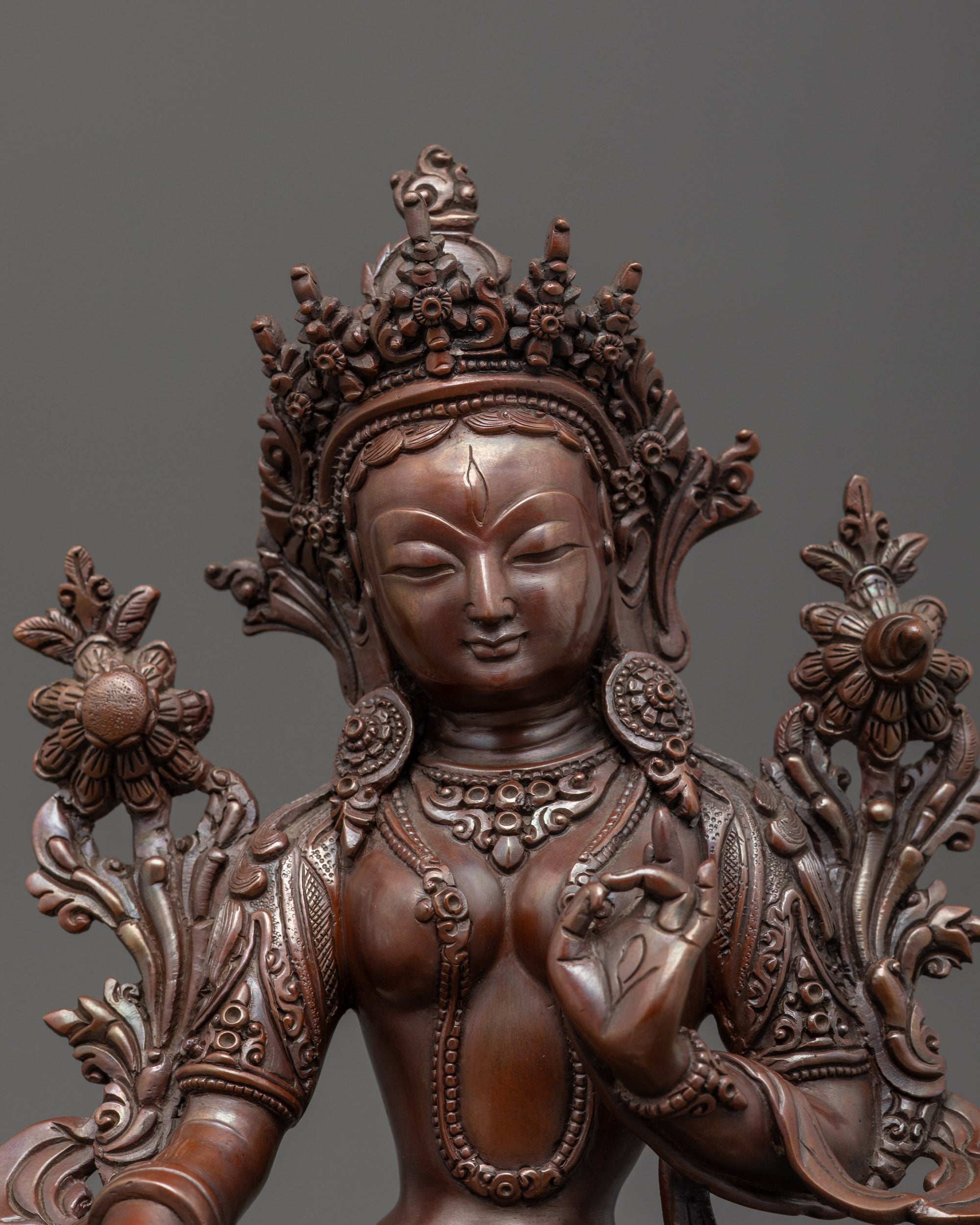Close-up of White Tara’s gold-gilded face and semi-precious stone inlays