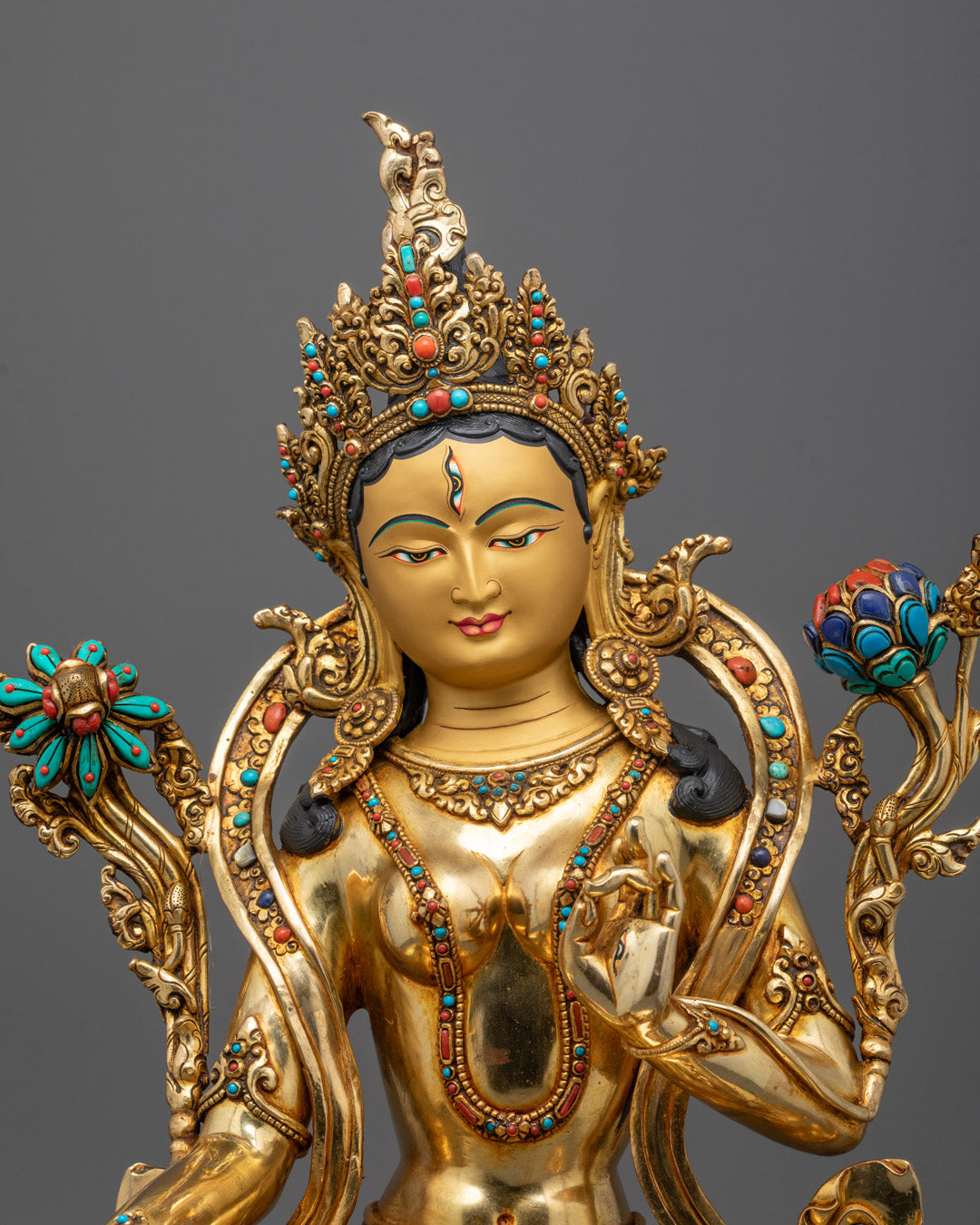 Close-up of White Tara’s peaceful face adorned with semi-precious stones