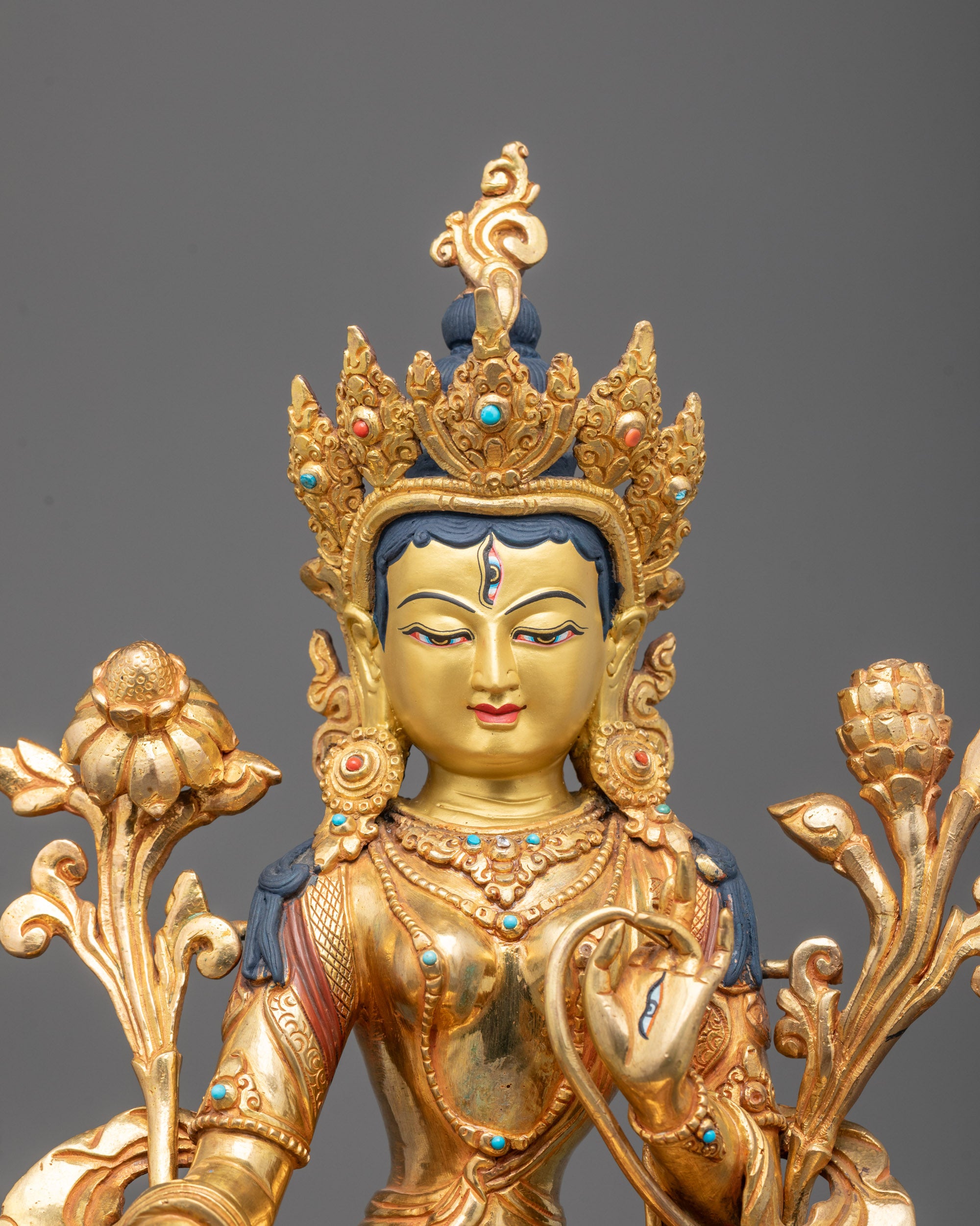 Close-up of White Tara’s serene expression and intricately detailed crown with gold finish