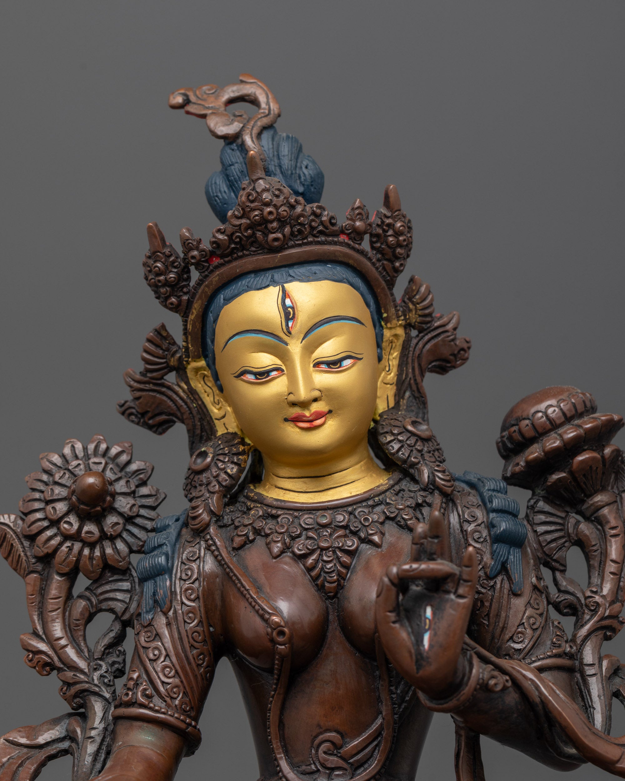 Close-up of White Tara’s serene face, jeweled crown, and seven seeing eyes
