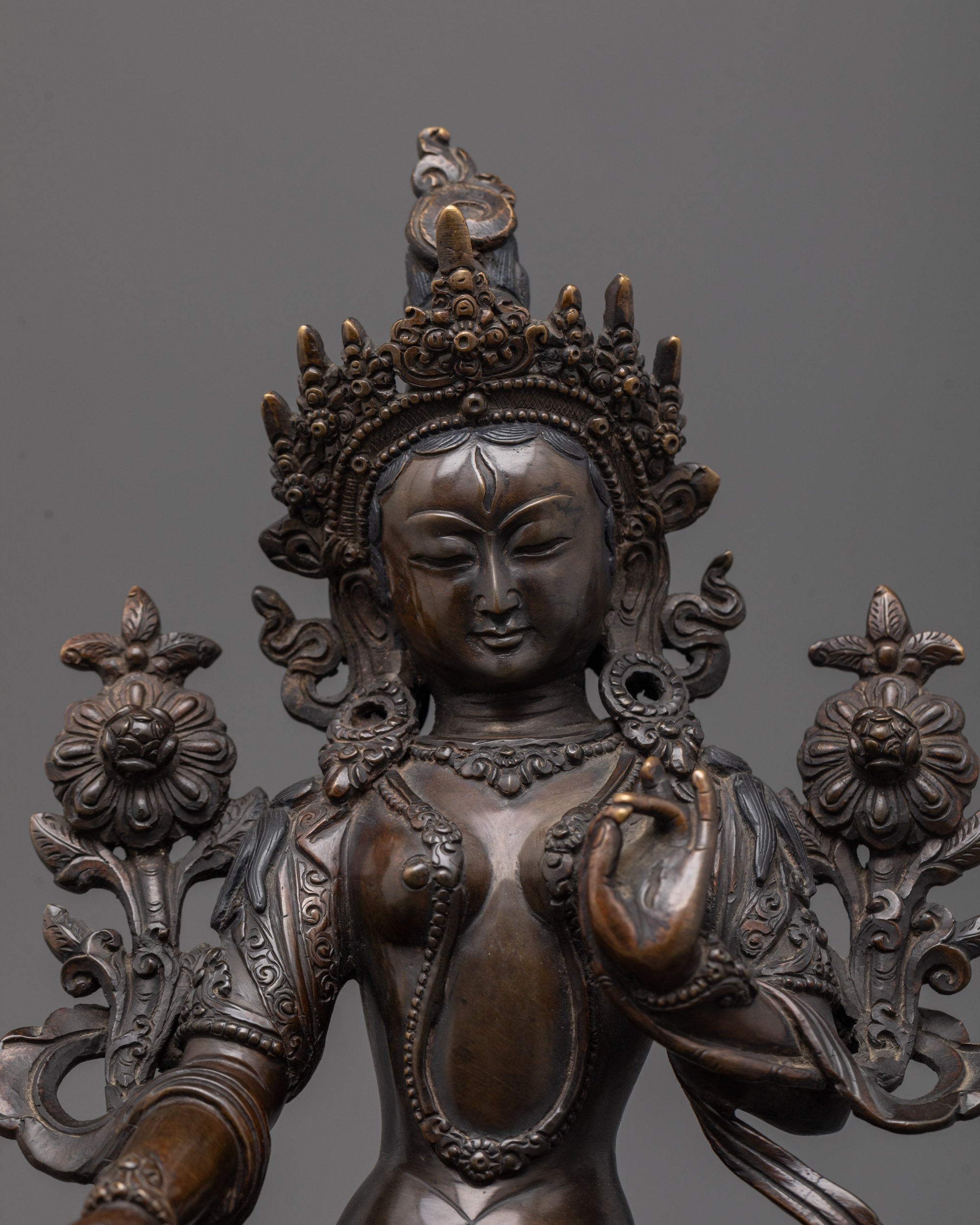 Close-up of White Tara's serene face with oxidized finish