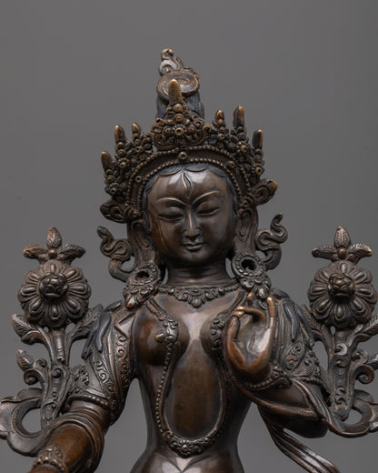 Close-up of White Tara's serene face with oxidized finish