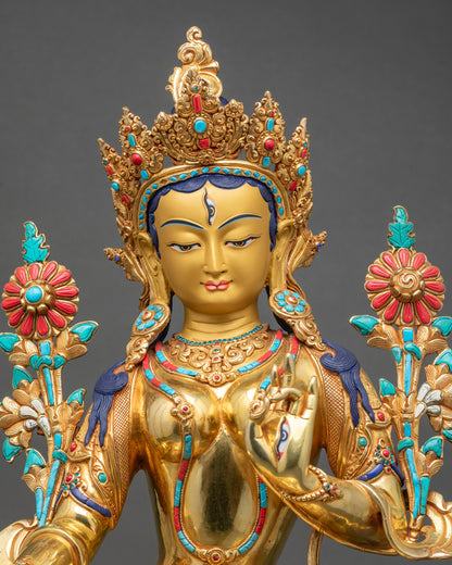 Close-up of White Tara sculpture, detailed hand-painted floral halo and serene gold face
