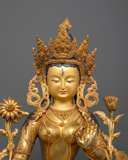 Close-up of White Tara statue face, 24K gold-gilded, Nepalese artisan work. Seven eyes.