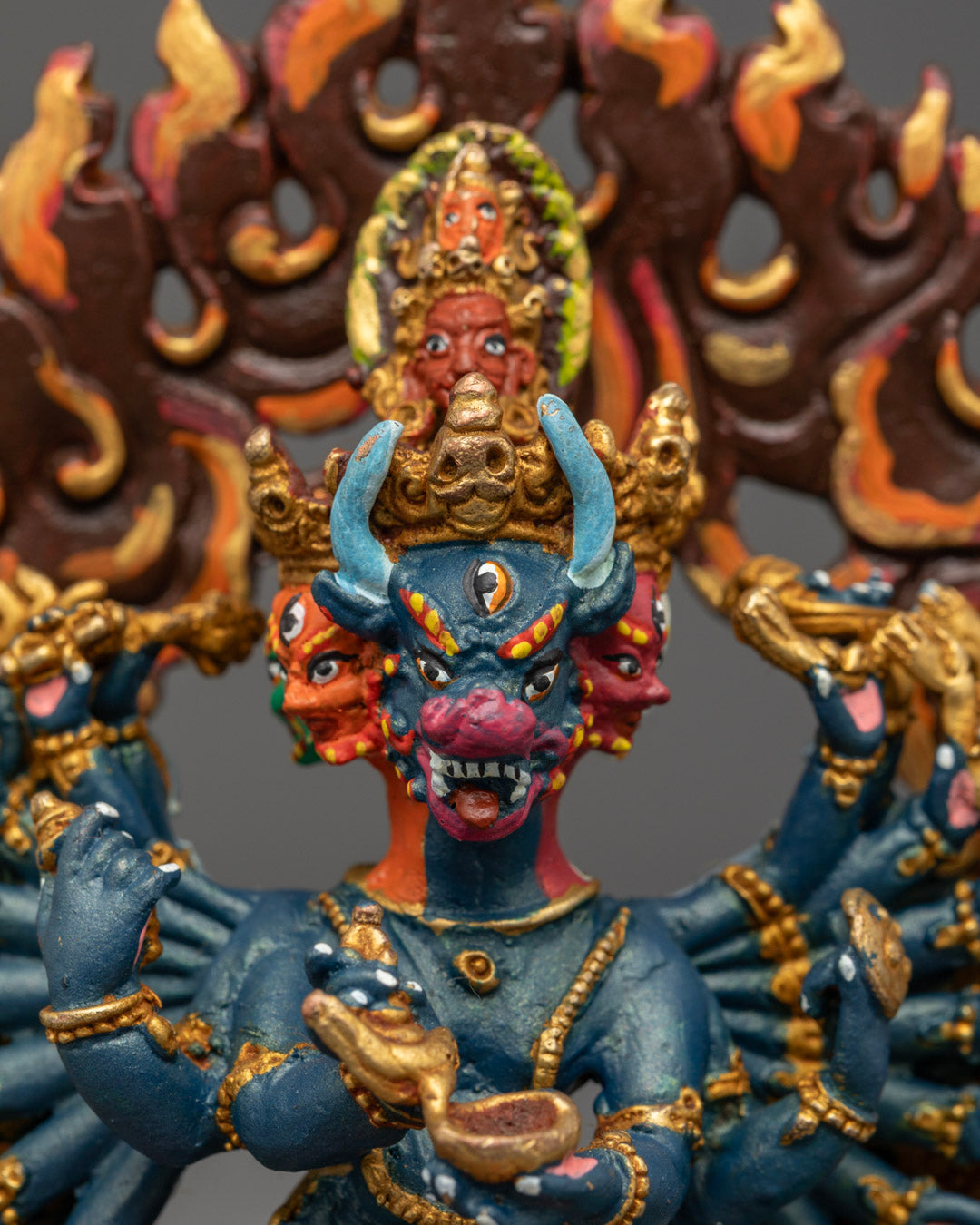 Yamantaka's fierce expression and multi-armed form on a premium copper statue with silver finish and colorful accents.