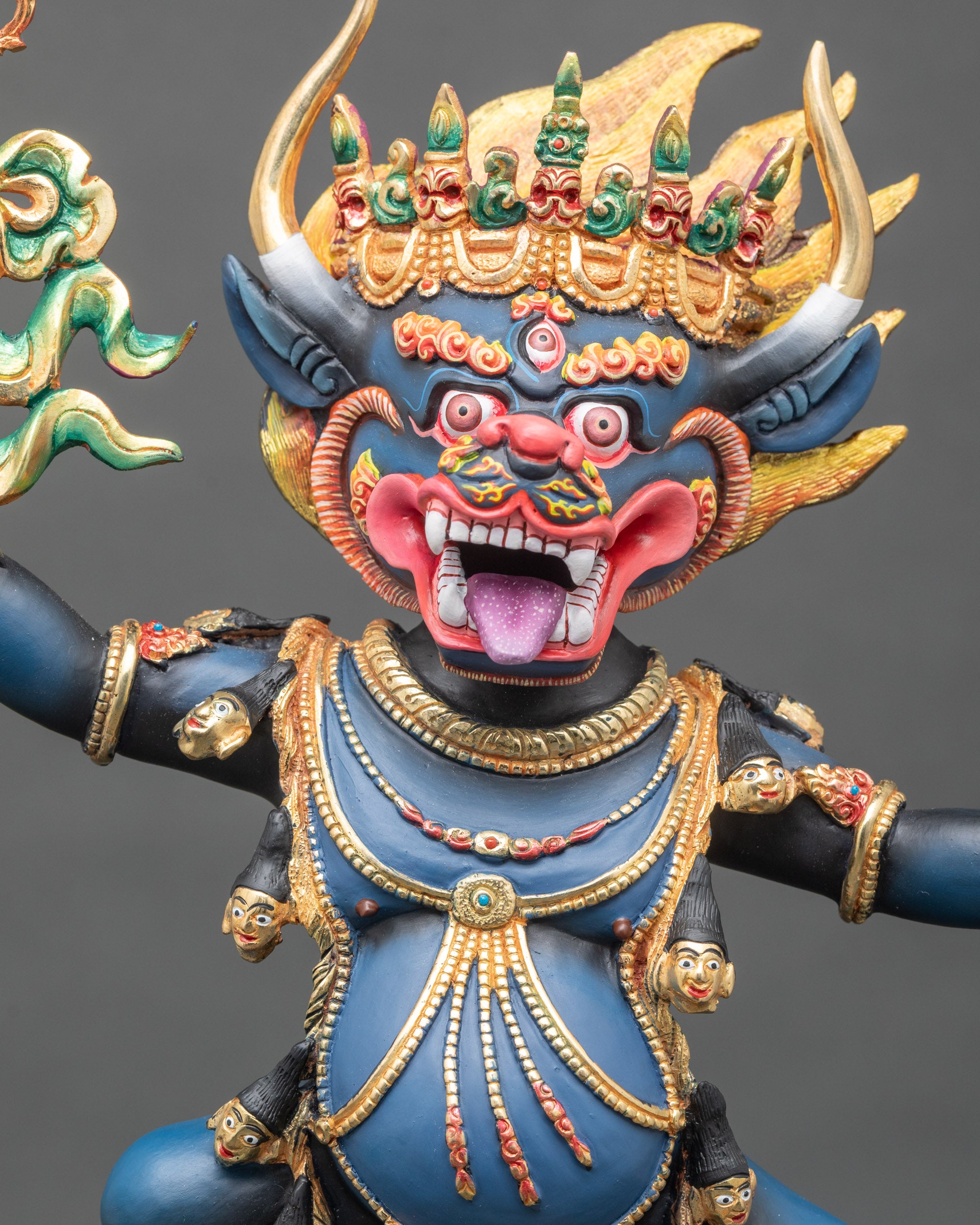 Close-up of Yamantaka statue showing ornate garlands, lotus seat, and buffalo head