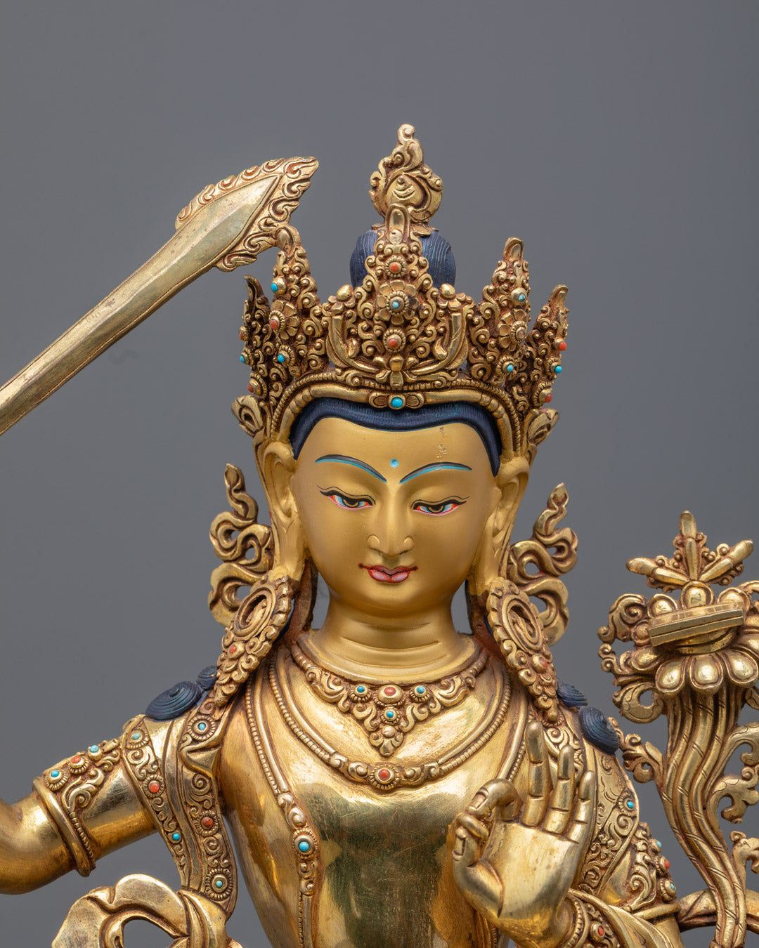 Manjushri statue showing intricate details of the flaming sword and colorful acrylic paint.