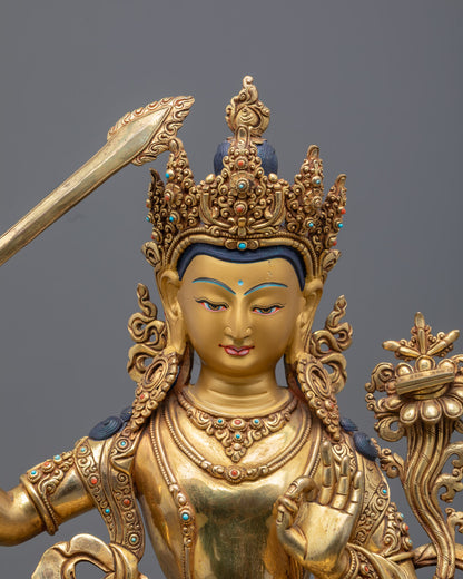 Manjushri statue showing intricate details of the flaming sword and colorful acrylic paint.