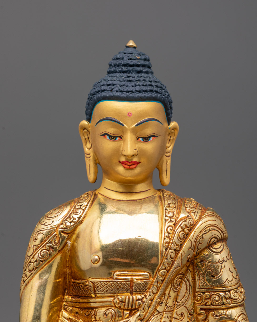 Close-up of a master artisan handcrafting a gilded Buddha statue in Patan, Nepal,