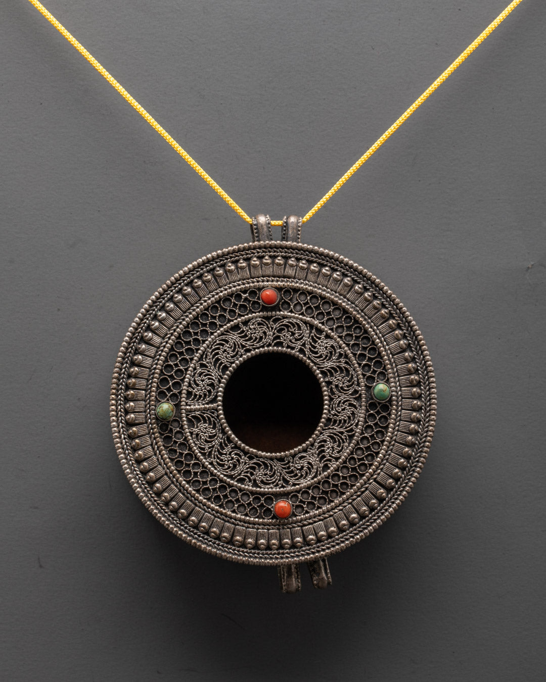 Close-up of a silver-plated Mandala Locket adorned with colorful semi-precious stones