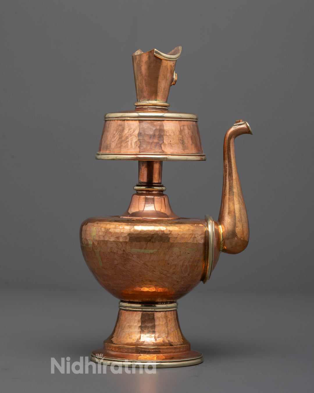 Close-up of detailed copper craftsmanship on the Chegumba