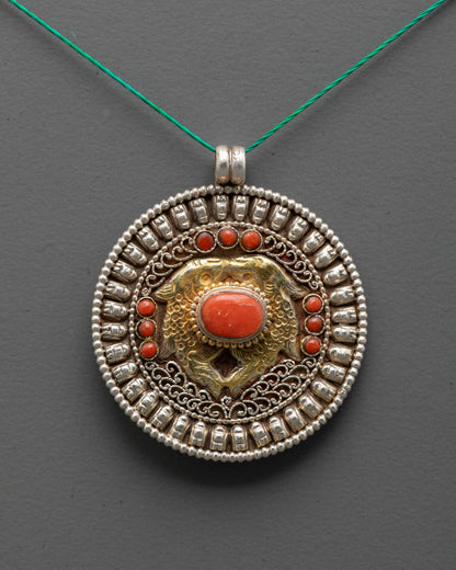 Close-up of gold-gilded Golden Fish with coral stones on Buddhist locket