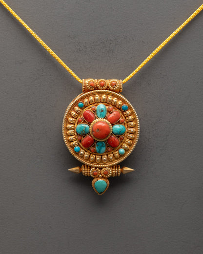 Close-up of gold-gilded Tibetan prayer box pendant showing intricate artisan details

