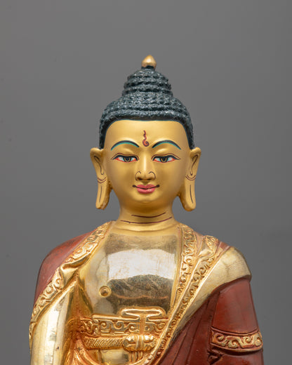 Close-up of gold-gilded face and intricate craftsmanship on Shakyamuni Buddha Statue