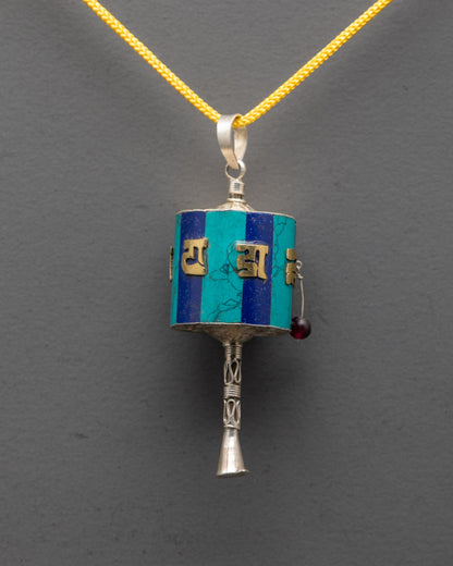 Close-up of gold-plated mantra detail on Prayer Wheel Locket crafted by Nepal artisans