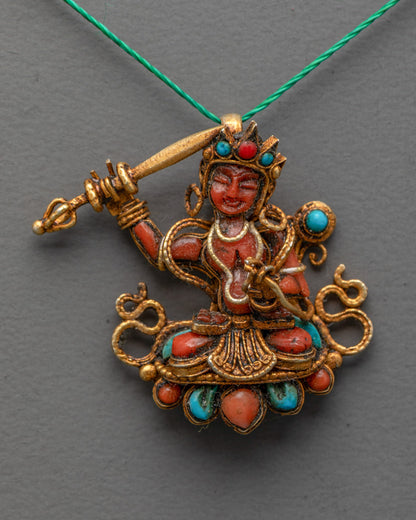 Close-up of gold filigree design on Tibetan Coral Manjushri wisdom pendant