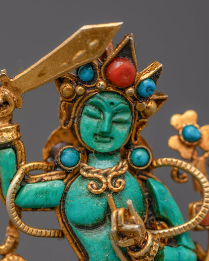 Close-up of gold filigree design on handcrafted Tibetan Manjushri pendant
