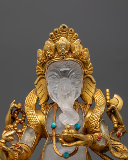Close-up of hand-carved Ganesh face with coral and turquoise inlays