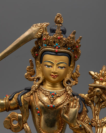 hand-carved Manjushri statue with 24k gold fire-gilded finish and semi-precious stones