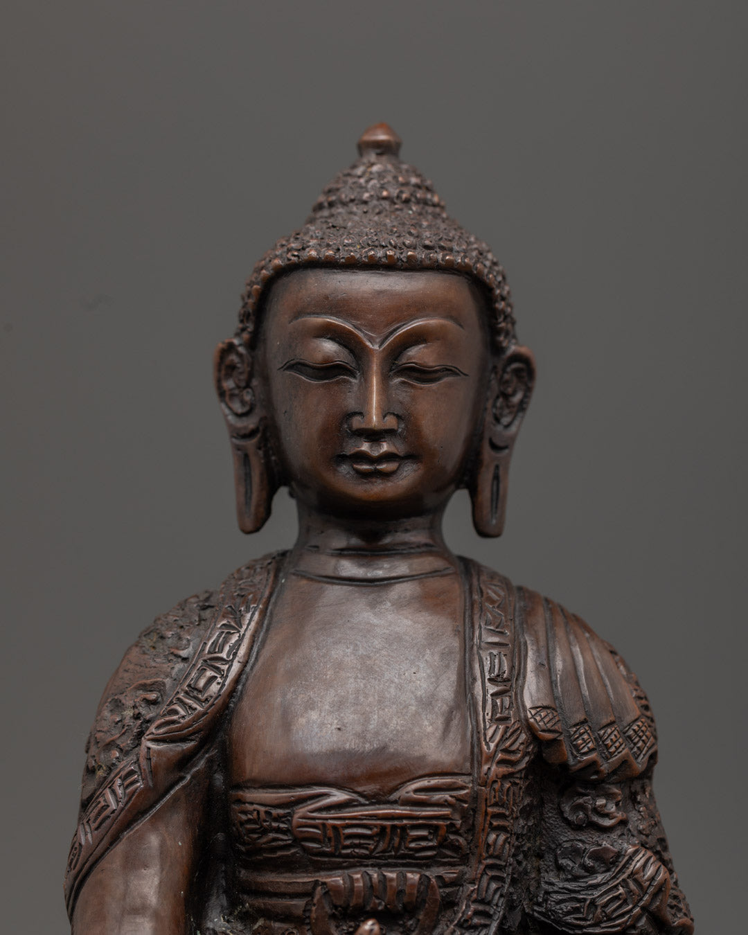 hand-carved Medicine Buddha statue with serene expression