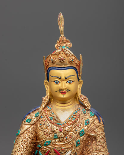 Close-up of hand holding vajra and bell on Guru Rinpoche Statue showcasing symbolic tantric elements