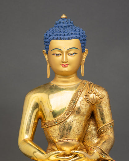 Close-up of handcrafted Amitabha Buddha showing gold fire-gilded details and robe carvings