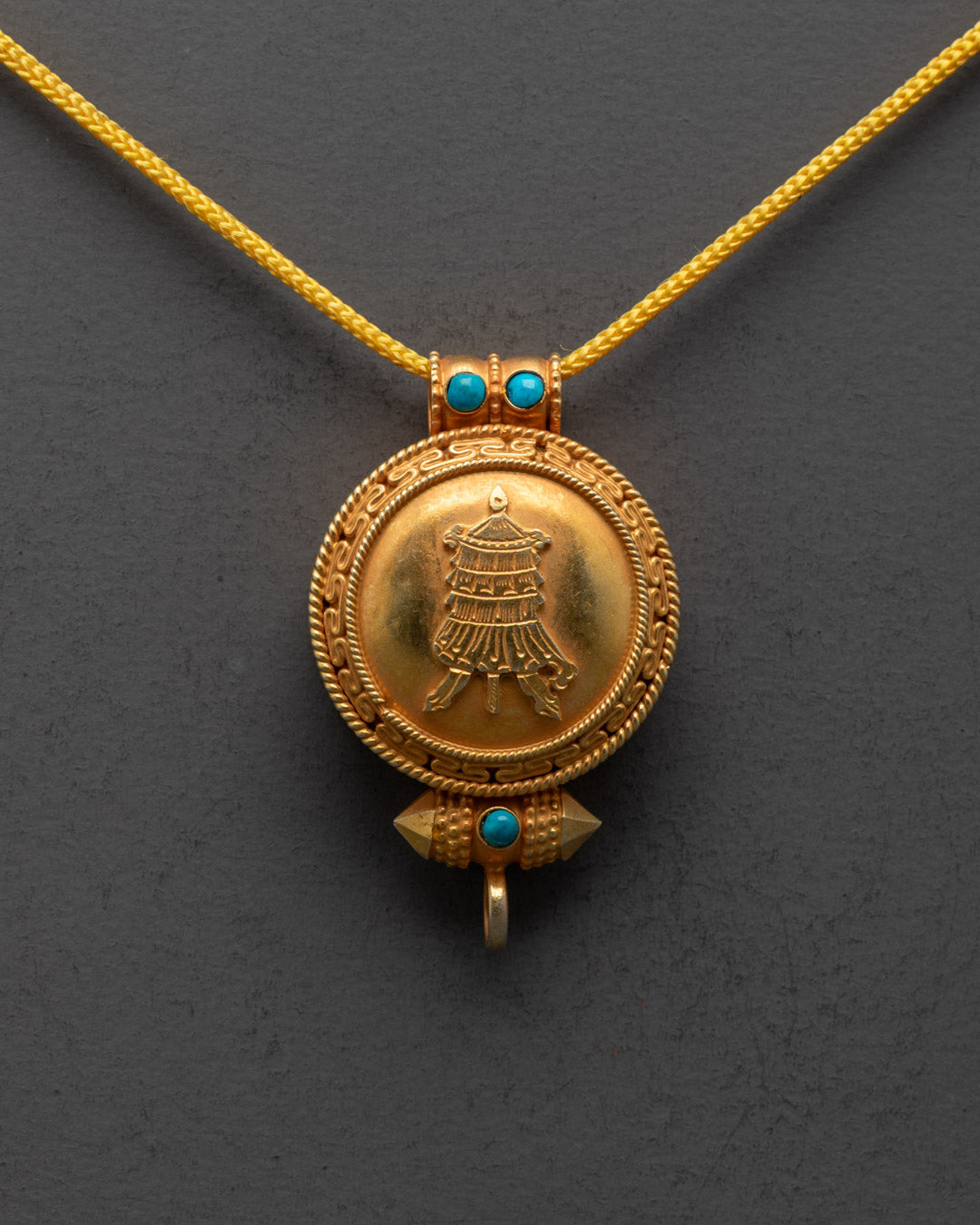 Close-up of handcrafted Gyeltshen design and detailed carvings on Tibetan locket