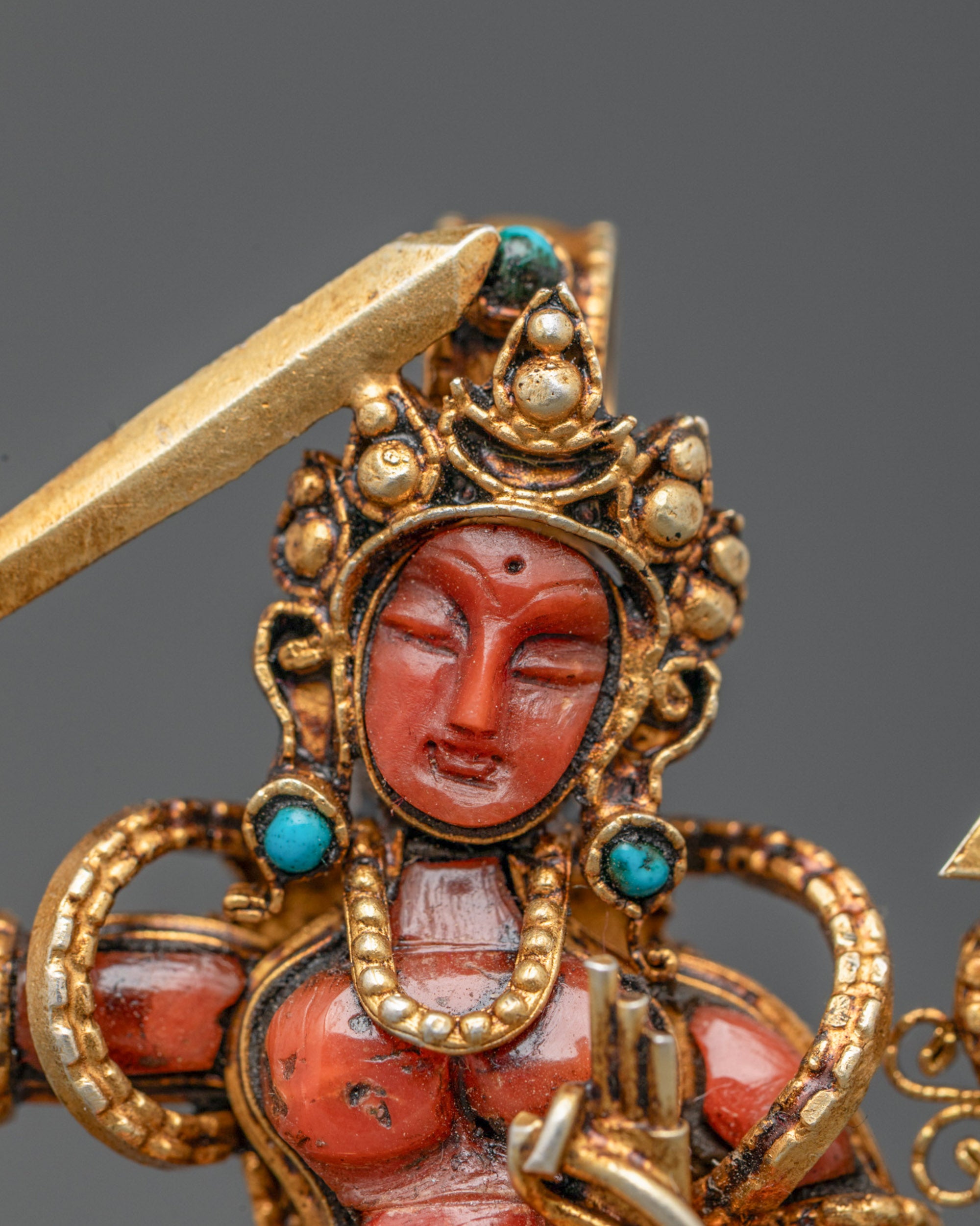 Close-up of handcrafted Manjushri Locket showing gold-gilded jewelry and gemstone accents
