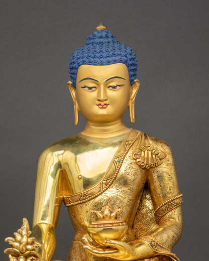 Close-up of handcrafted Medicine Buddha showing gold fire-gilded details and robe carvings