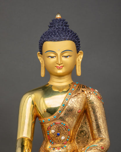 Close-up of handcrafted Shakyamuni Buddha showing gold fire-gilded details and robe carvings