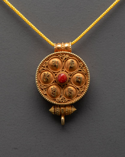 Close-up of handcrafted coral Tibetan Ghau Prayer Box Locket with filigree design