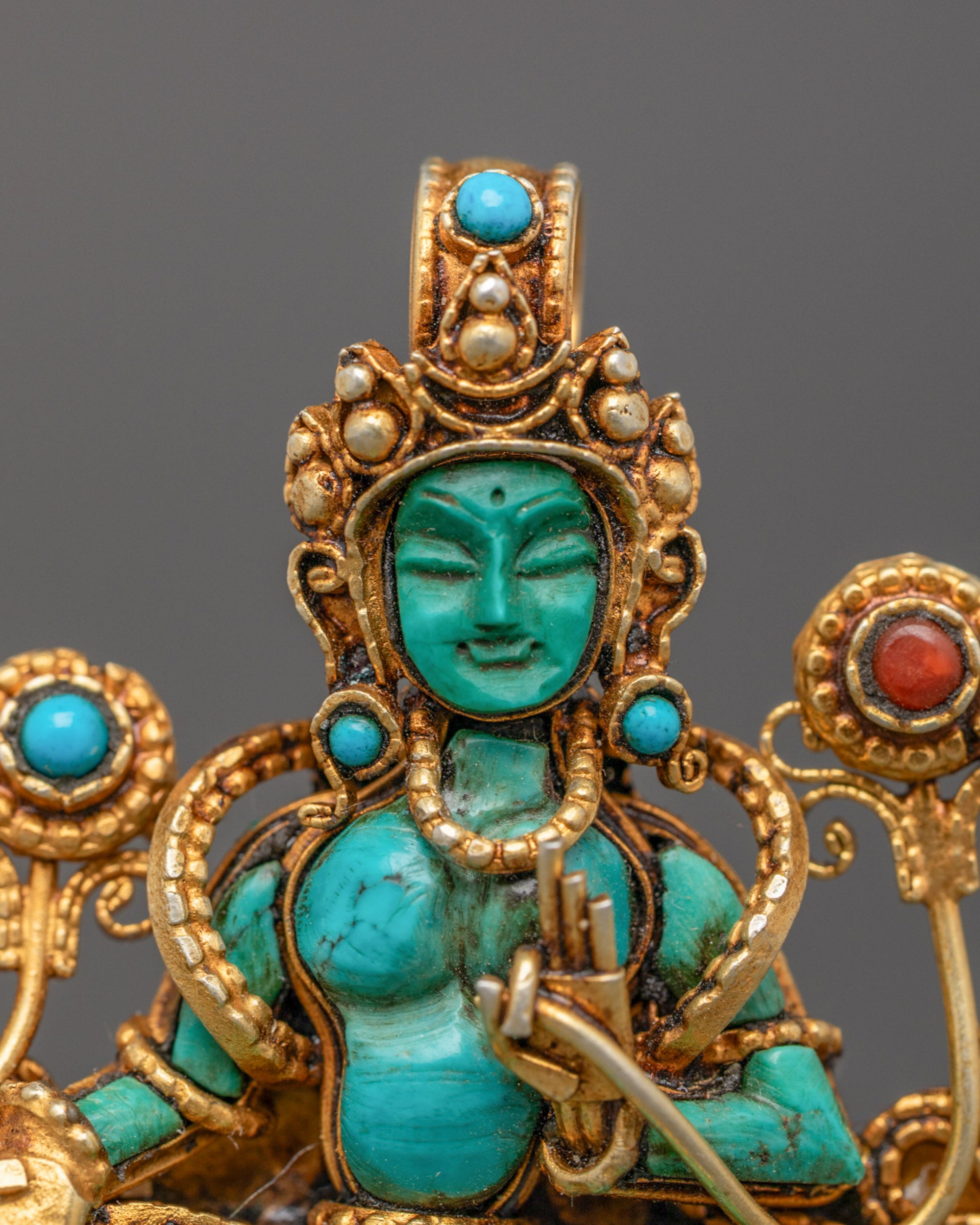 Close-up of handmade Green Tara Locket adorned with semi-precious stones
