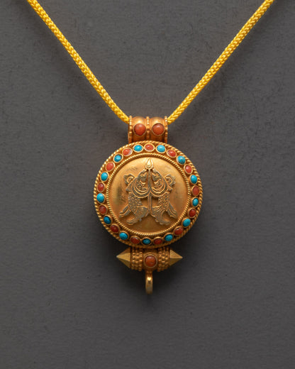 Close-up of intricate Golden Fish carving on Tibetan amulet locket with sacred details