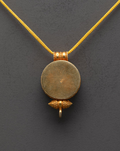 Close-up of intricate Golden Fish on Tibetan amulet locket with sacred details

