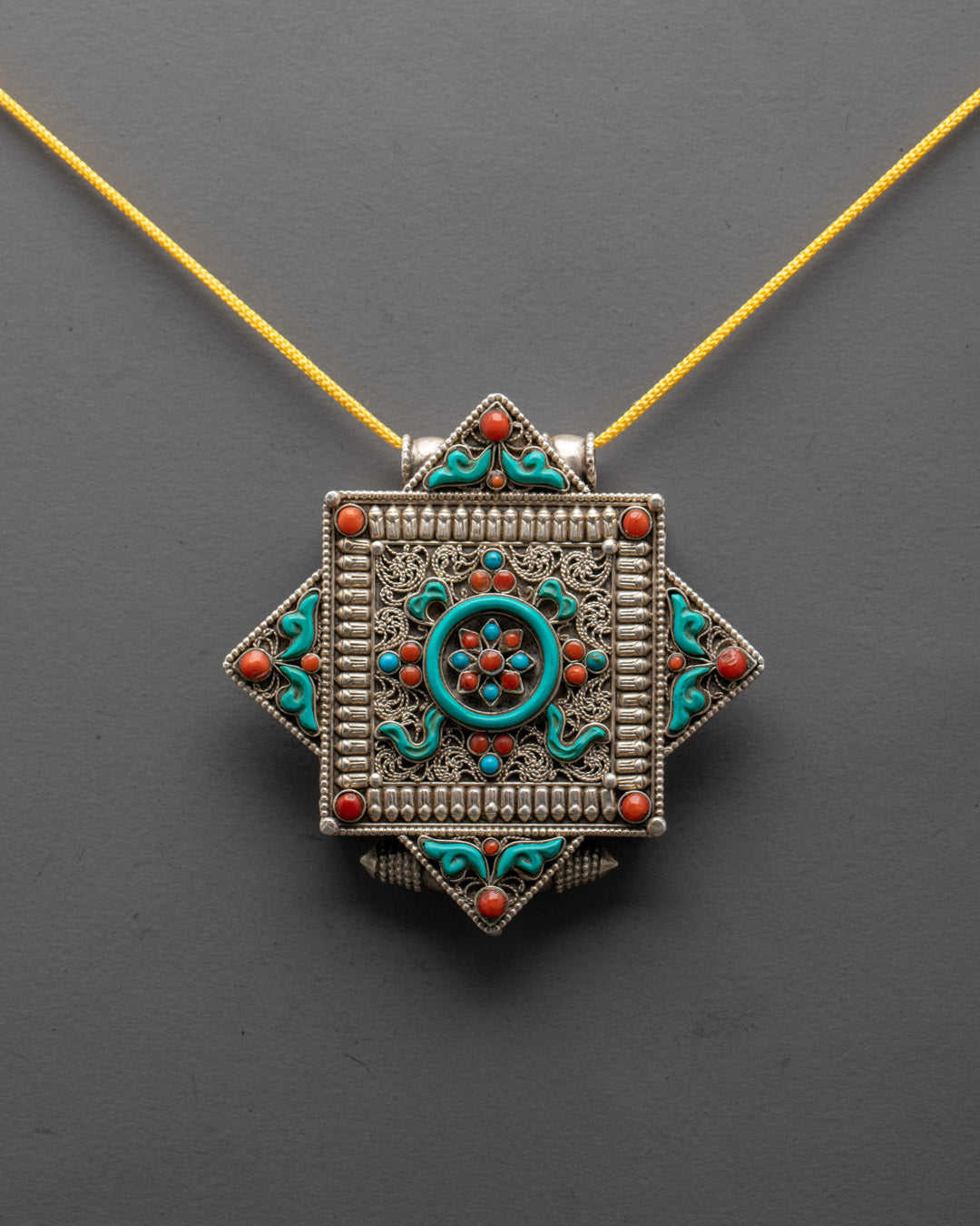 Close-up of intricate Mandala Locket carvings and gemstone details