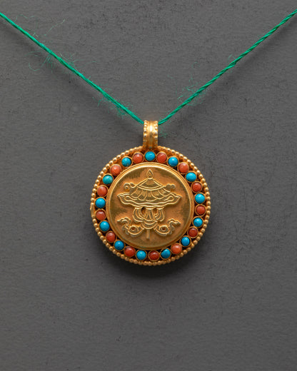 Close-up of intricate Victory Banner design on gold-plated copper pendant with stone details
