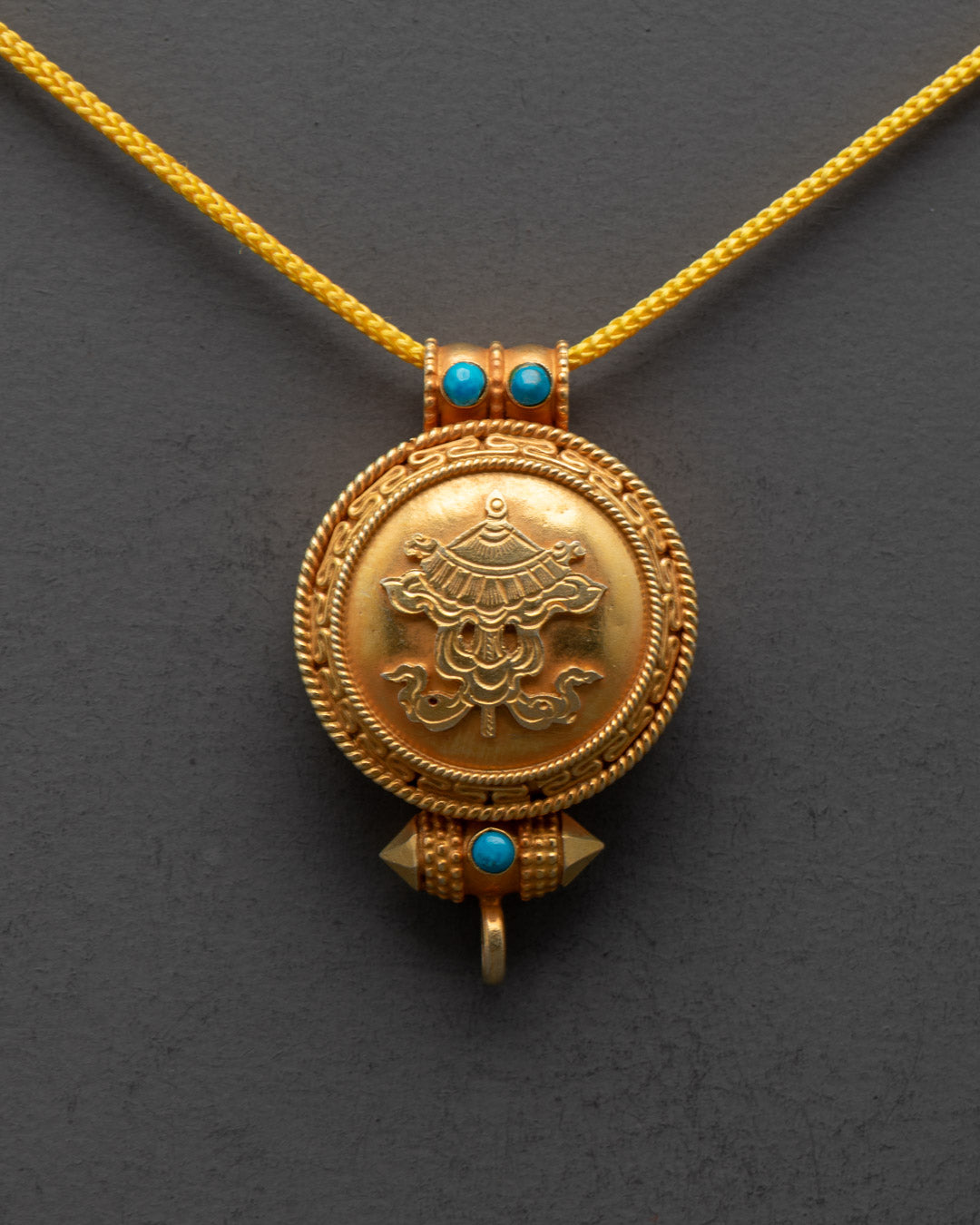 Close-up of intricate carvings on Parasol Locket symbolizing protection and spiritual shelter