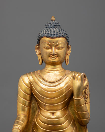 Close-up of intricate details on gold-plated Standing Buddha statue