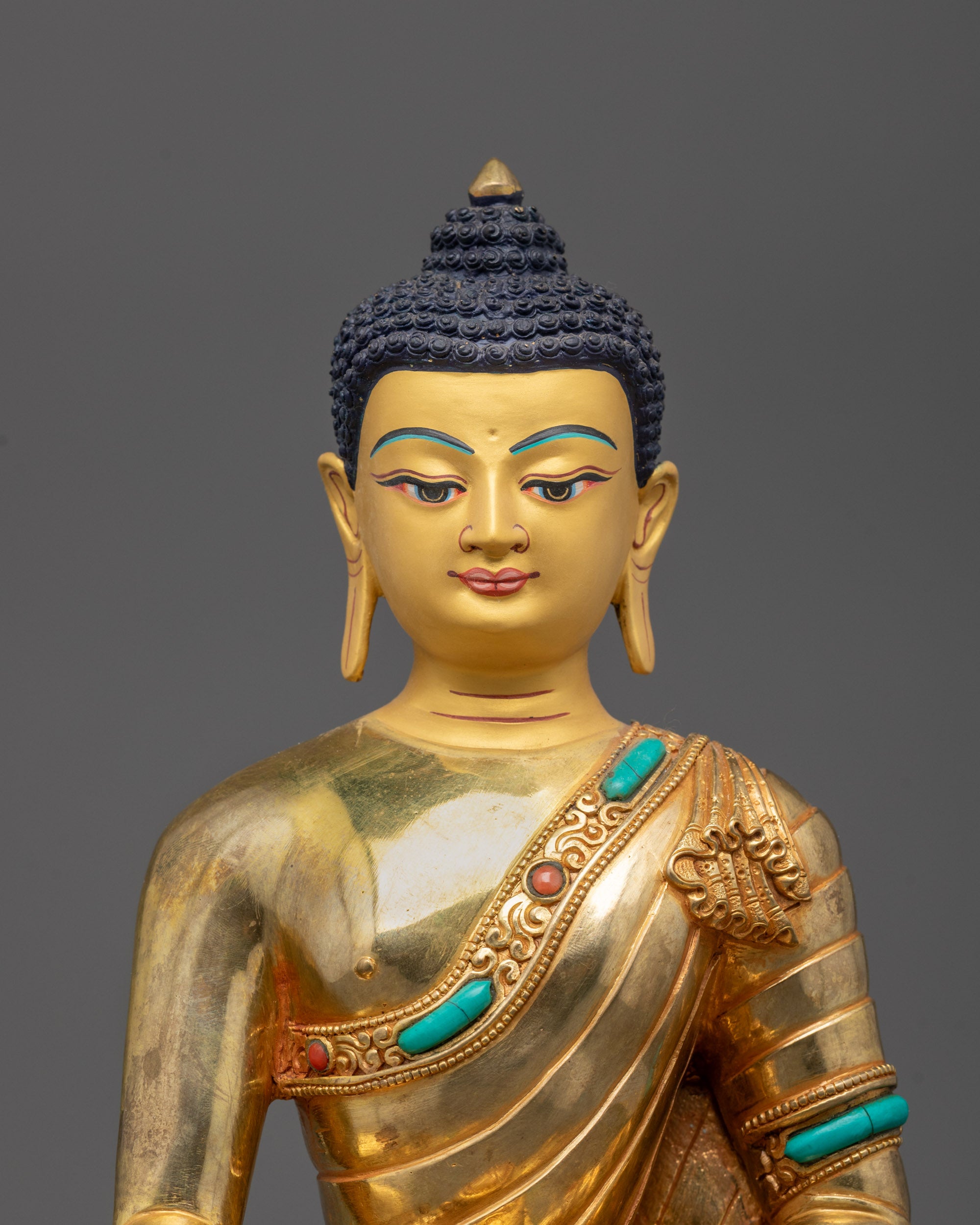 Close-up of intricate details on the Shakyamuni Buddha Statue showing gold gilding
