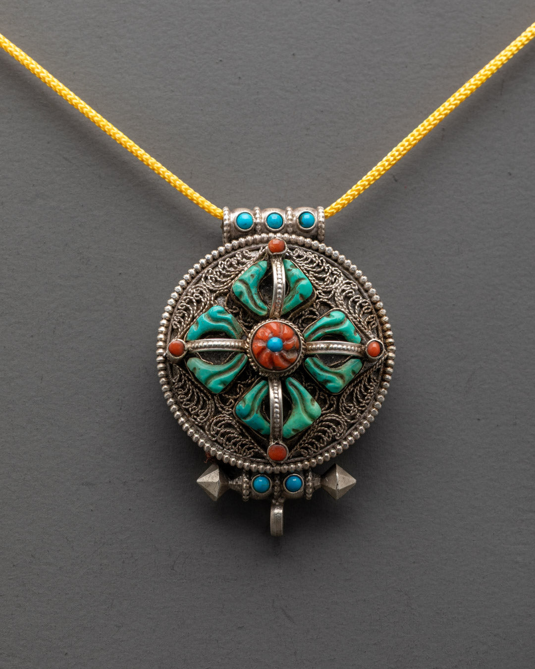 Close-up of intricate filigree design on Bishwo Vajra Locket adorned with lapis lazuli