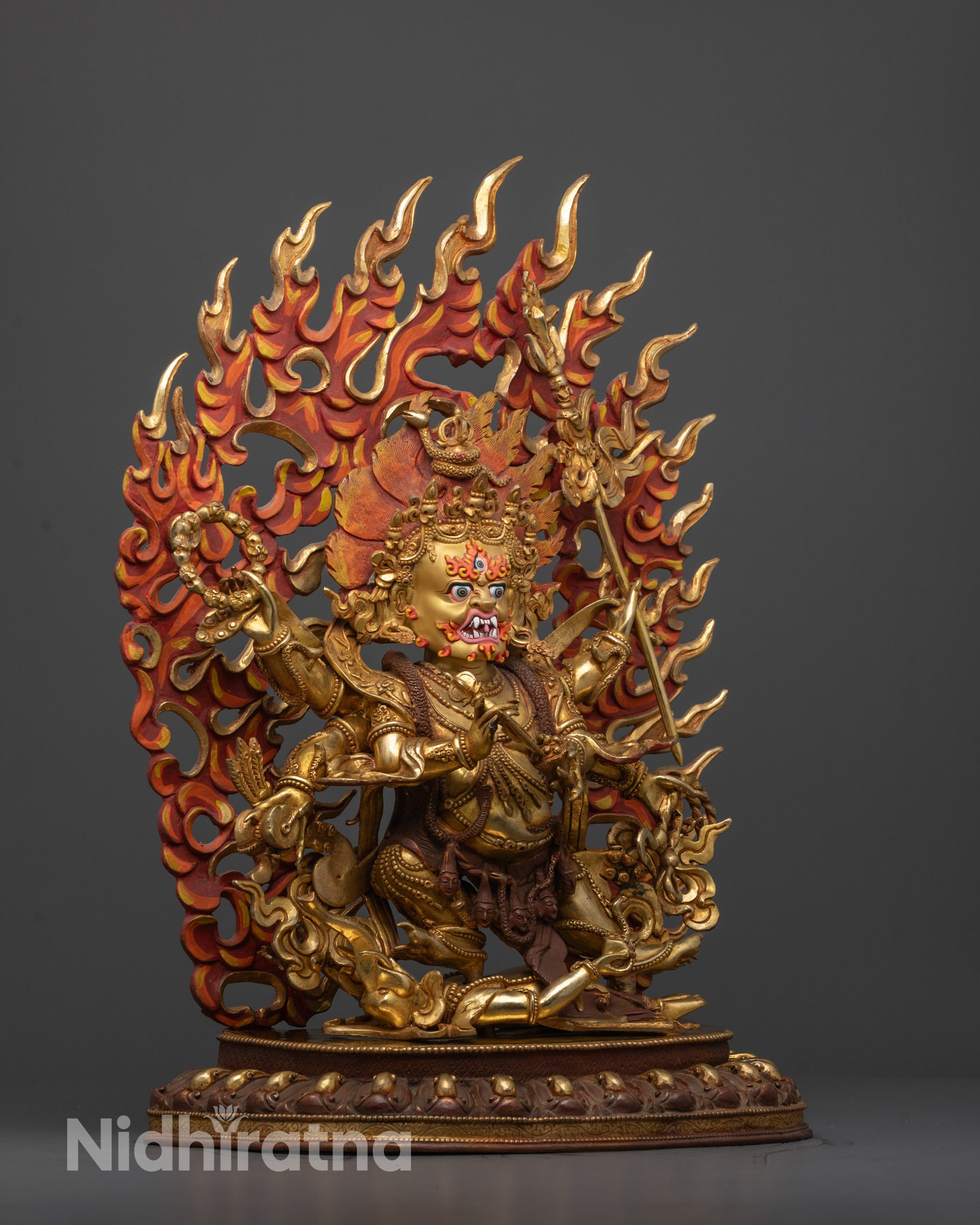 Close-up of intricate halo, crown, mala, and trident carvings on Mahakala sculpture