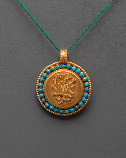 Close-up of intricate lotus design on gold-plated copper locket with gemstone accents