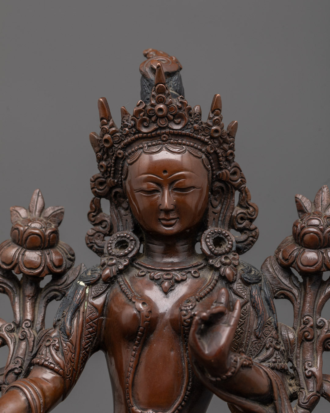 Close-up of intricate oxidized copper Green Tara statue showcasing detailed craftsmanship
