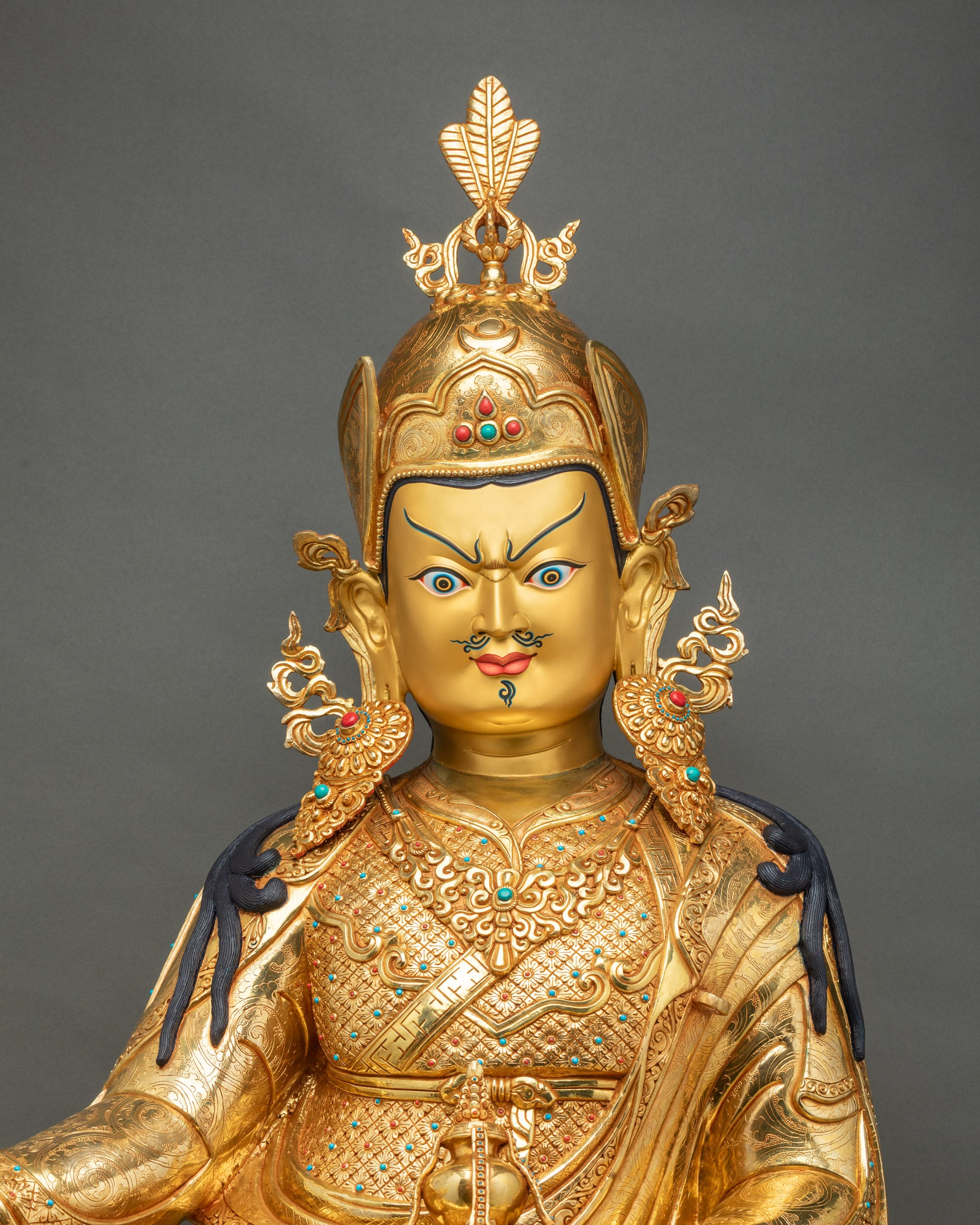 Close-up of life-size Guru Rinpoche statue, 24k gold fire-gilded copper, semi-precious stone inlay, Nepali Buddhist art