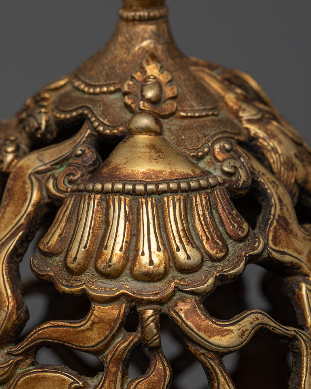 Close-up of ornate design and gold detailing on antique-style incense burner