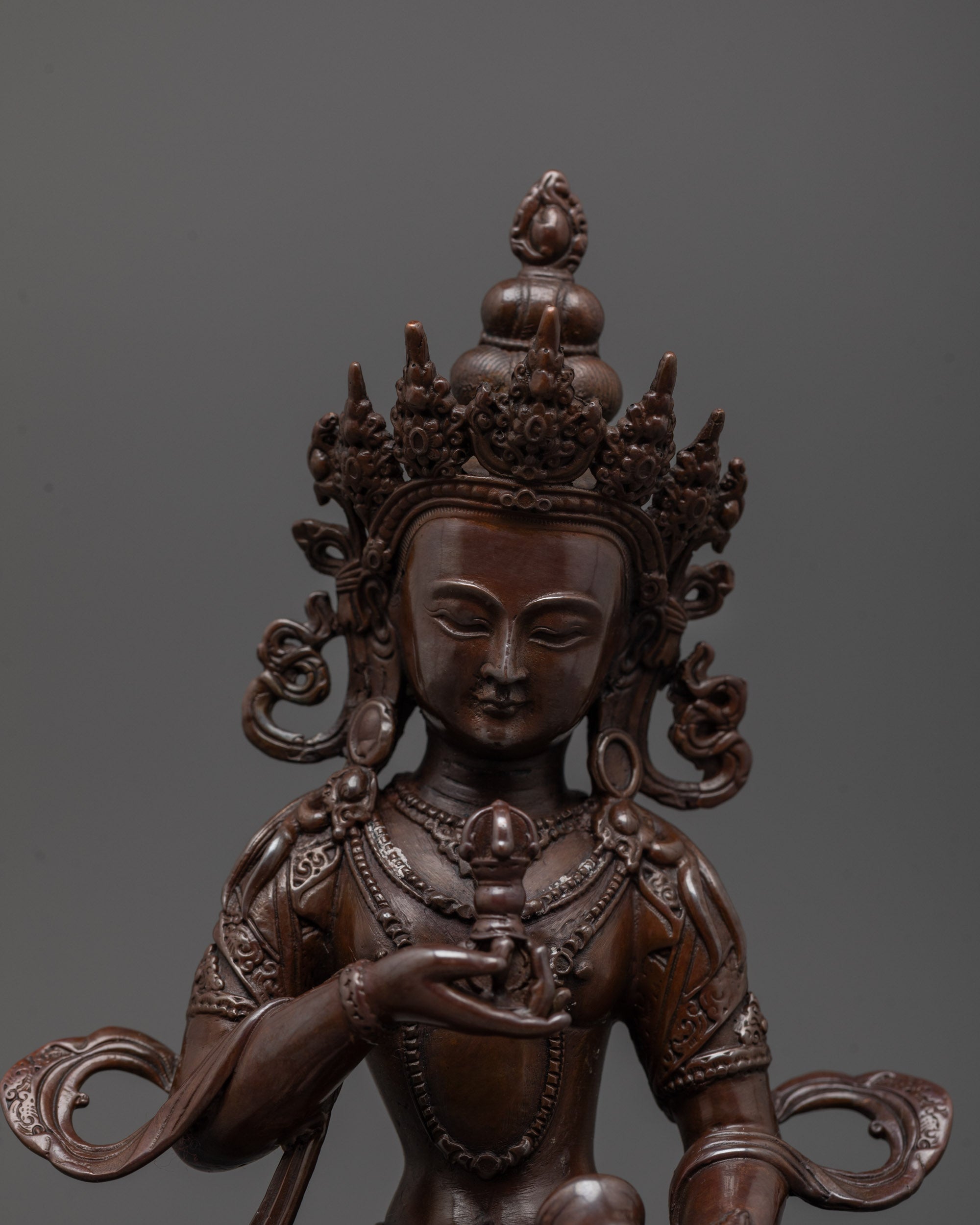 Close-up of oxidized Vajrasattva statue showing vajra, bell, and precise electroplated finish
