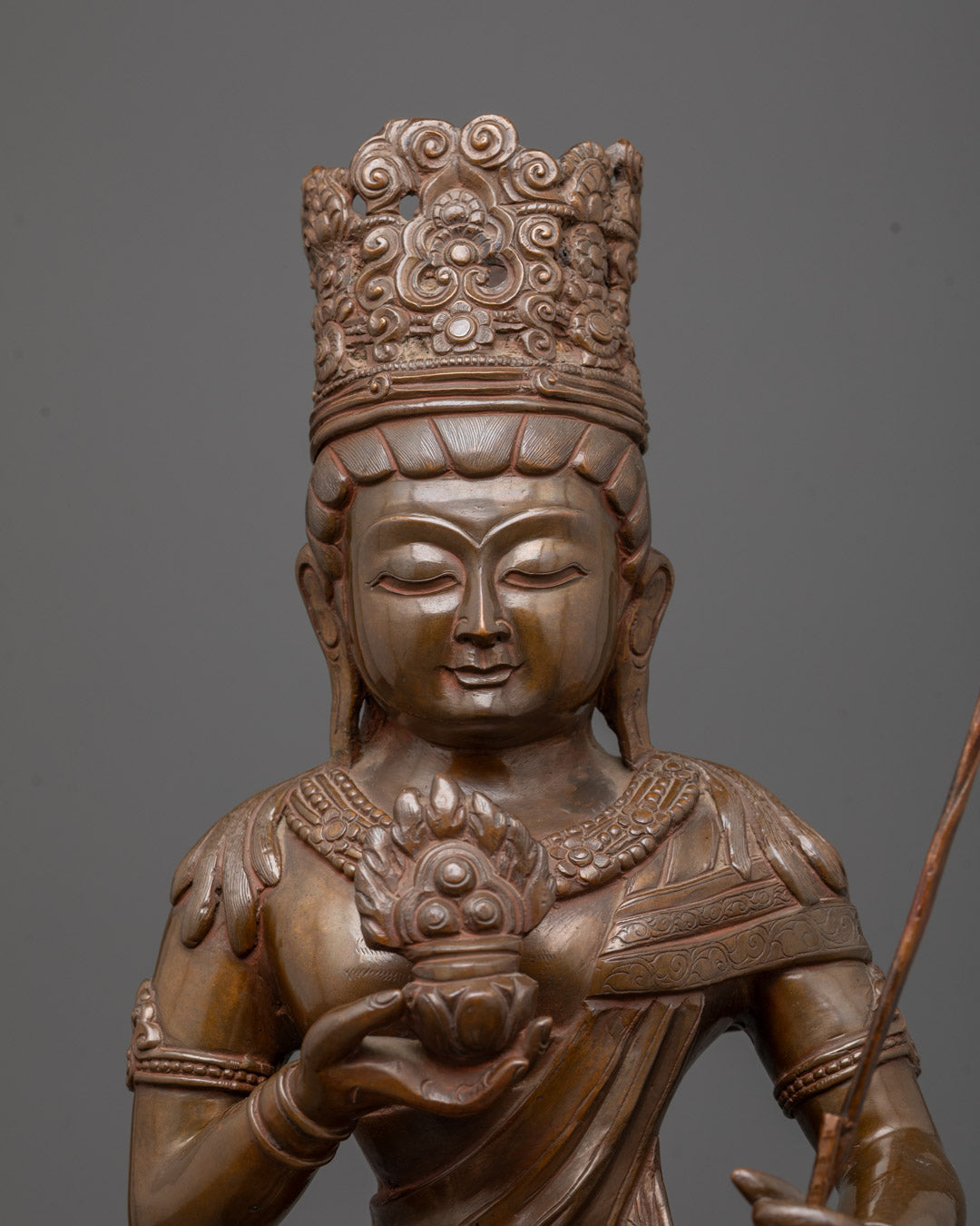Close-up of oxidized copper Akasagarbha statue showing detailed crown and jewelry carvings