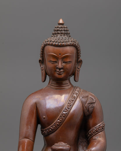 Close-up of oxidized copper Shakyamuni Buddha face with serene expression