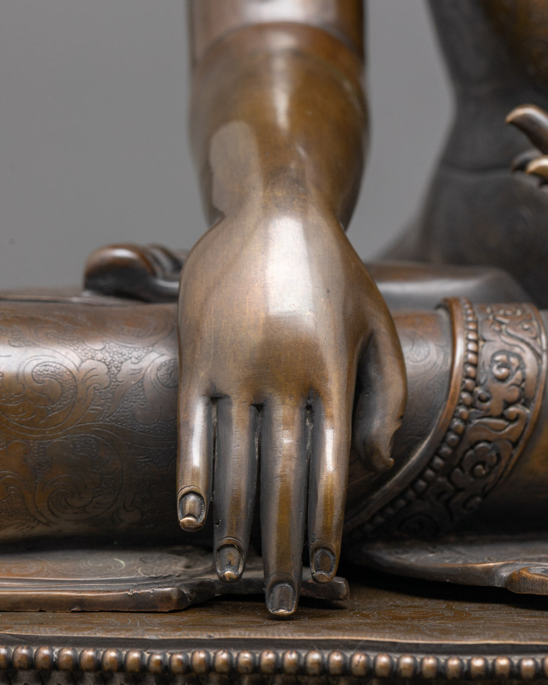 Close-up of oxidized copper Shakyamuni Buddha sculpture showing intricate craftsmanship