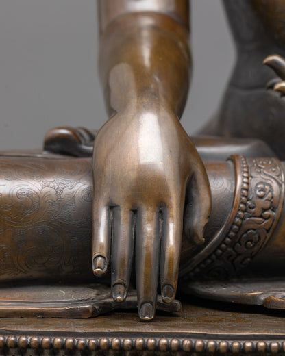 Close-up of oxidized copper Shakyamuni Buddha sculpture showing intricate craftsmanship